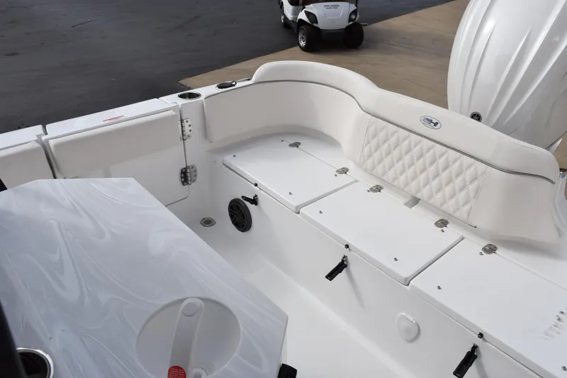 Slide: The Image of 2026 Sea Hunt Ultra 245 SE boat interior with white seating and storage compartments. - 8