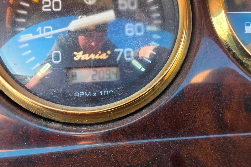 Slide: The Image of Dashboard of a 2004 Sanpan 2500 RE boat with gauges and wooden steering wheel. - 10