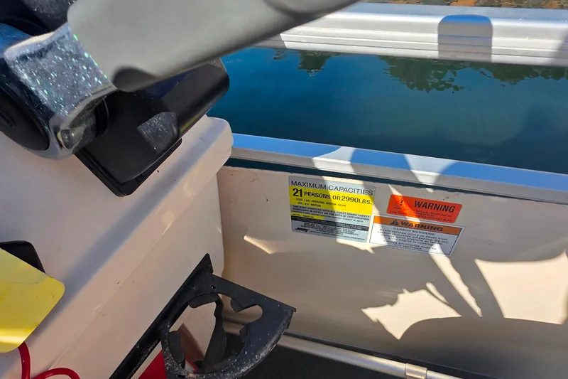 Slide: The Image of 2004 Sanpan 2500 RE boat interior with logo on white upholstery. - 16