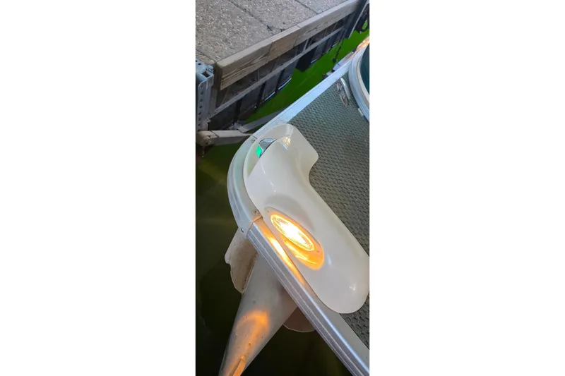 Slide: The Image of 2004 Sanpan 2500 RE boat corner with illuminated navigation lights. - 21