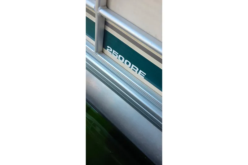 Slide: The Image of 2004 Sanpan 2500 RE boat with illuminated deck light near dock. - 22