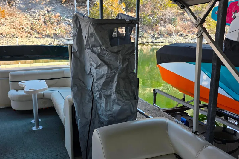 Slide: The Image of 2004 Sanpan 2500 RE boat seat with built-in cup holders, beige upholstery. - 27