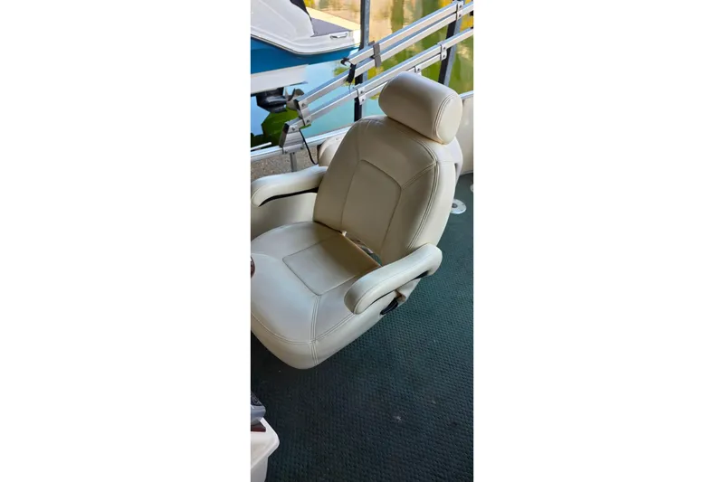 Slide: The Image of 2004 Sanpan 2500 RE pontoon boat interior with seating and covered equipment. - 28