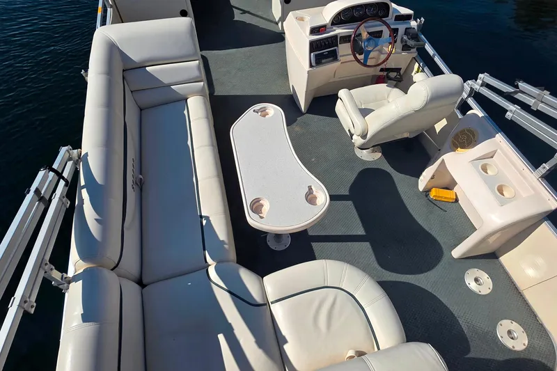 Slide: The Image of 2004 Sanpan 2500 RE pontoon boat interior with seating and steering console. - 3