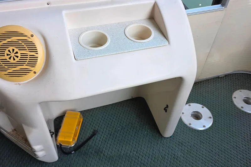 Slide: The Image of 2004 Sanpan 2500 RE pontoon boat interior with beige seating and table. - 30