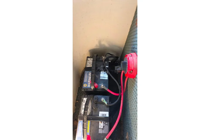 Slide: The Image of Yamaha 225 outboard motor on 2004 Sanpan 2500 RE boat, docked on green water. - 34