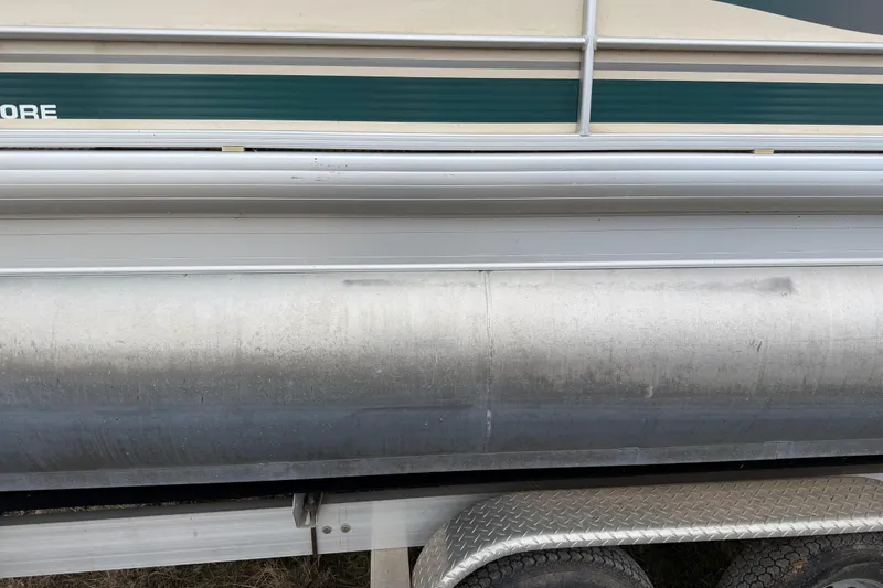 Slide: The Image of 2004 Sanpan 2500 RE pontoon boat side view, showing aluminum pontoon and trailer. - 41