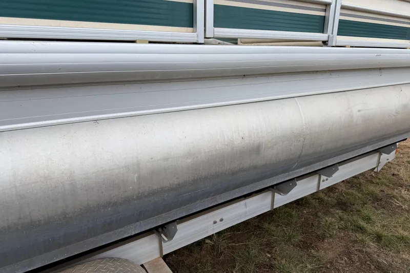 Slide: The Image of 2004 Sanpan 2500 RE pontoon boat side view, showing aluminum structure and railing. - 42