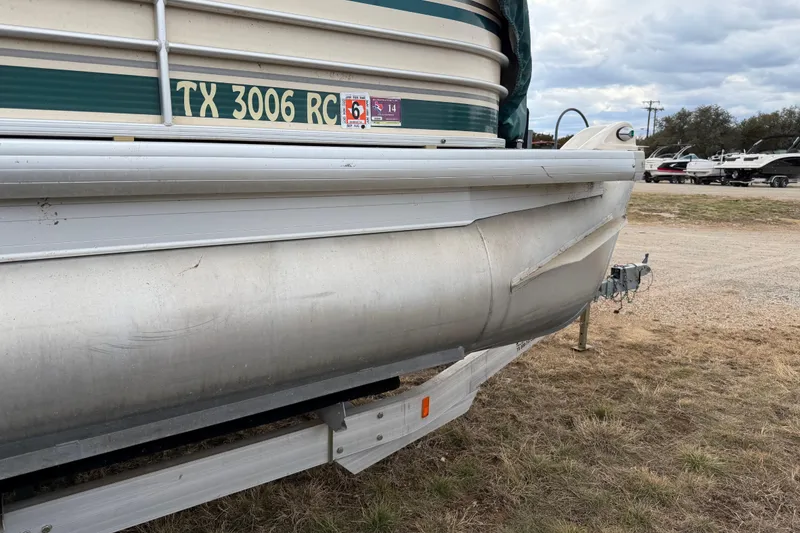 Slide: The Image of 2004 Sanpan 2500 RE pontoon boat on trailer, side view with registration number. - 46