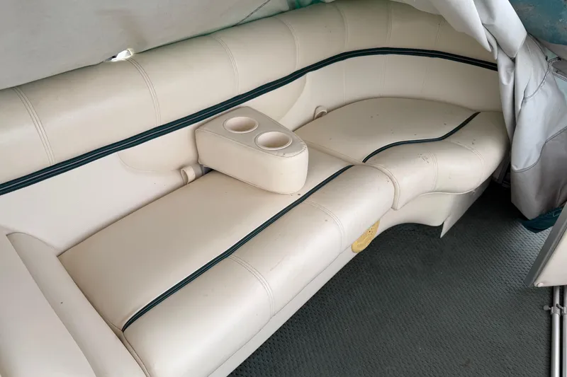 Slide: The Image of 2004 Sanpan 2500 RE boat interior with cream leather seating and cup holders. - 52