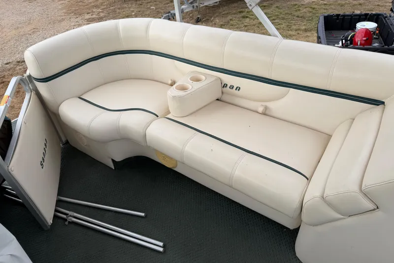 Slide: The Image of 2004 Sanpan 2500 RE boat interior with cream seating and cup holders. - 54