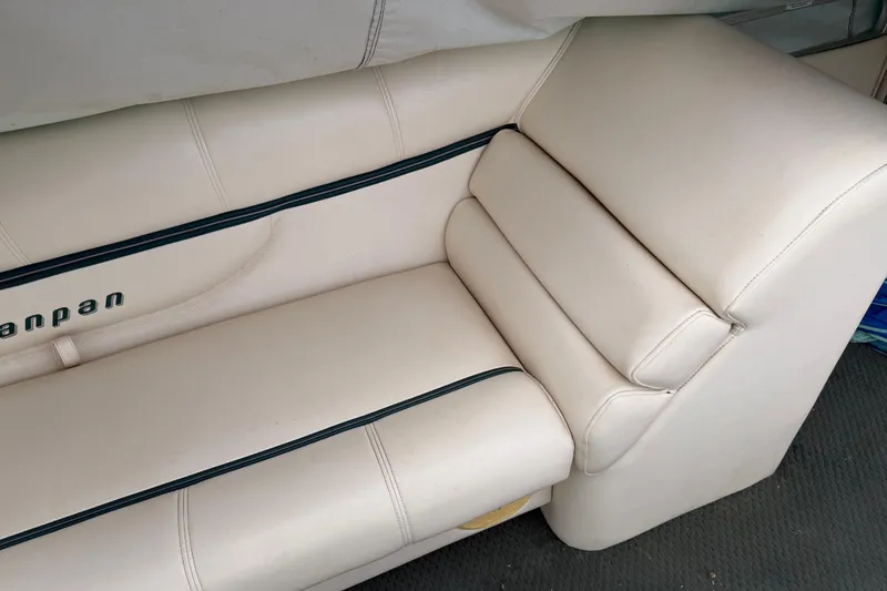 Slide: The Image of 2004 Sanpan 2500 RE boat seat with beige upholstery and black accents. - 57