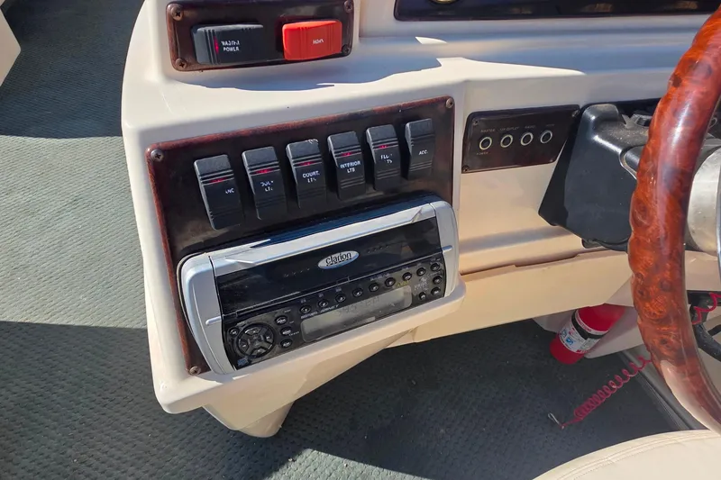 Slide: The Image of 2004 Sanpan 2500 RE boat dashboard with steering wheel and control panel. - 7