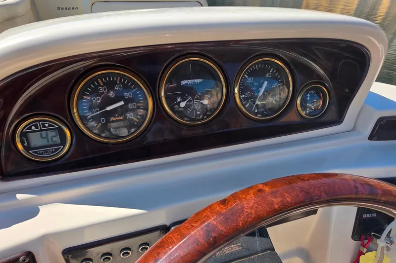 Slide: The Image of Dashboard of a 2004 Sanpan 2500 RE boat with gauges and controls. - 9