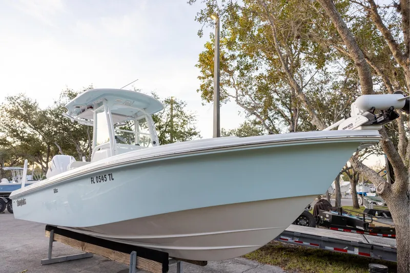 The Image of 2023 Everglades 243 Center Console boat on display, surrounded by trees. - 0