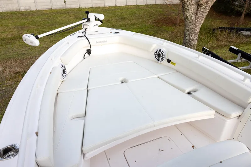 Slide: The Image of 2023 Everglades 243 Center Console boat with white cushioned seating and trolling motor. - 10