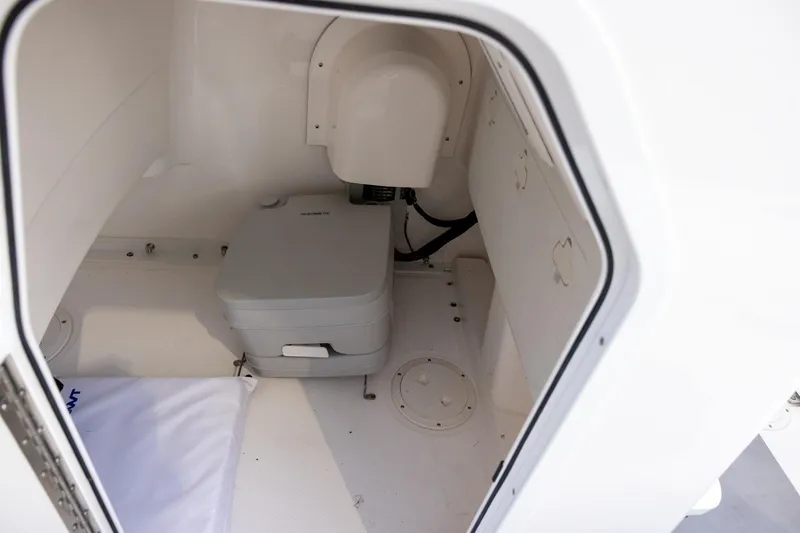 Slide: The Image of Interior of 2023 Everglades 243 Center Console boat with compact marine toilet. - 11