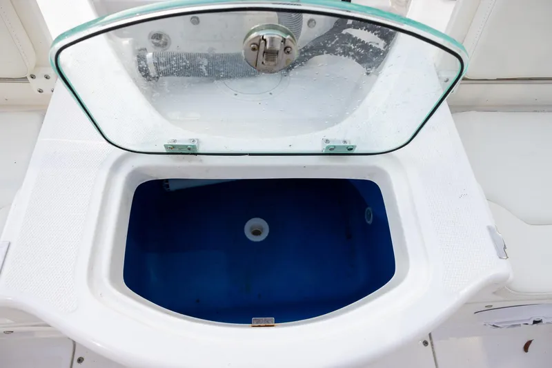Slide: The Image of Livewell on 2023 Everglades 243 Center Console boat with open lid. - 14