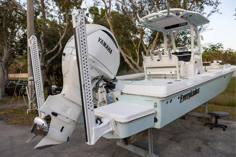 Slide: The Image of 2023 Everglades 243 Center Console boat with Yamaha engine, parked outdoors. - 3