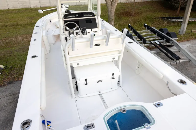 Slide: The Image of 2023 Everglades 243 Center Console boat interior with steering wheel and YETI cooler. - 4
