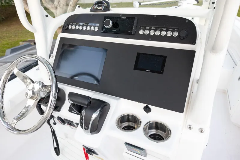 Slide: The Image of 2023 Everglades 243 Center Console dashboard with steering wheel and electronic controls. - 7