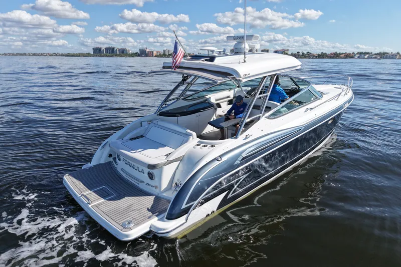 The Image of 2017 Formula 370 Super Sport boat cruising on open water under a clear sky. - 0