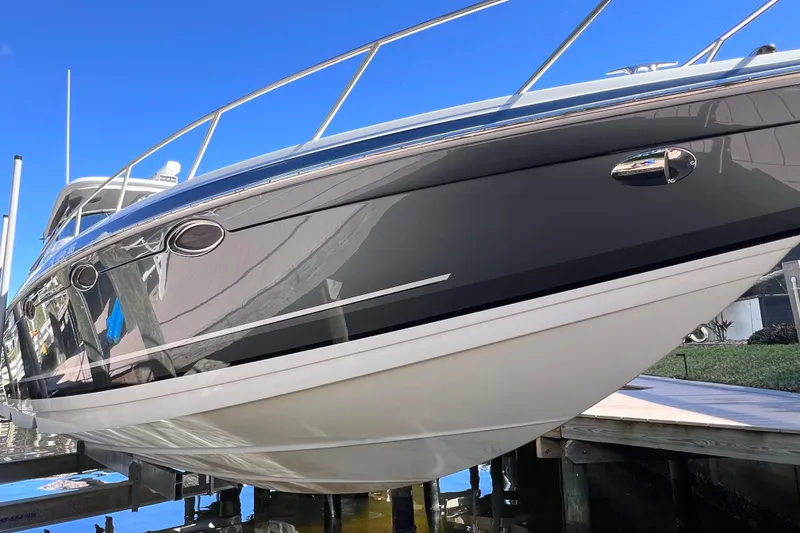 Slide: The Image of 2017 Formula 370 Super Sport boat on lift, sleek design, blue sky background. - 10