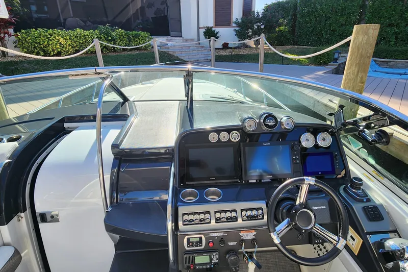 Slide: The Image of Cockpit view of a 2017 Formula 370 Super Sport boat with advanced navigation controls. - 36