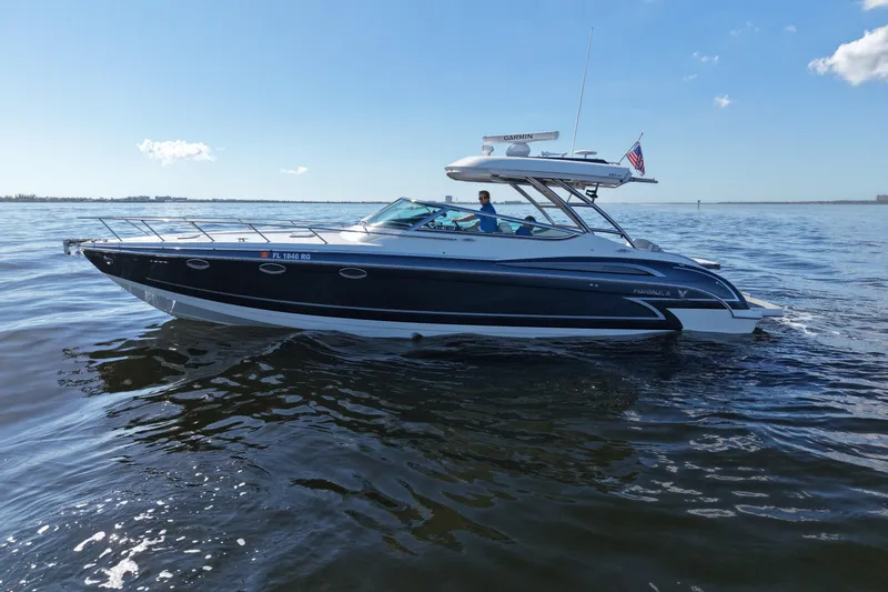 Slide: The Image of 2017 Formula 370 Super Sport boat cruising on open water under clear skies. - 4