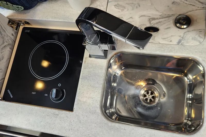 Slide: The Image of Compact kitchen area in a 2017 Formula 370 Super Sport boat with sink and stove. - 45