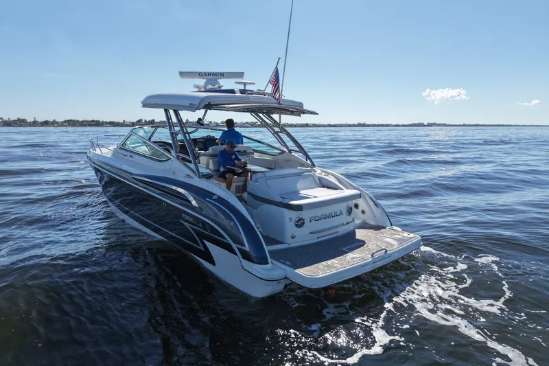 Slide: The Image of 2017 Formula 370 Super Sport boat cruising on open water under clear blue sky. - 5