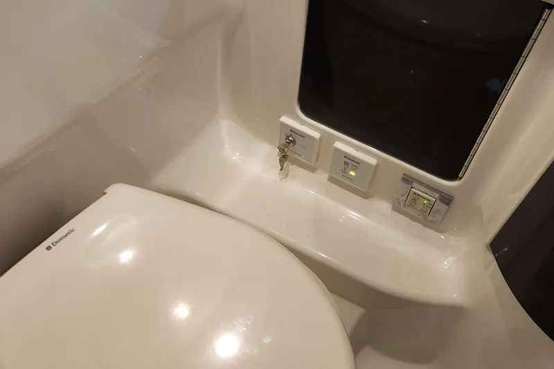 Slide: The Image of 2017 Formula 370 Super Sport boat bathroom with Dometic toilet and control panel. - 56