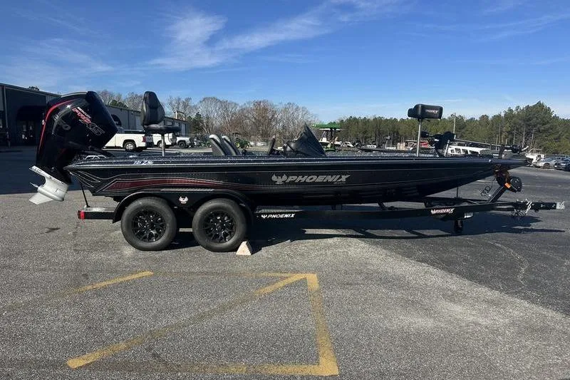 The Image of 2026 Phoenix 721 ZXL boat on trailer, parked outdoors under clear sky. - 1