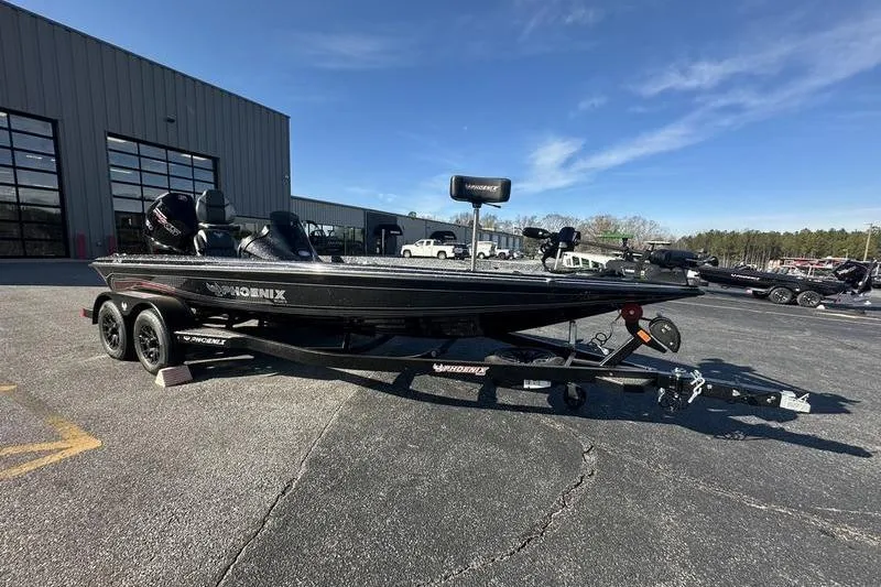 Slide: The Image of 2026 Phoenix 721 ZXL boat on trailer, parked outside dealership under clear blue sky. - 4