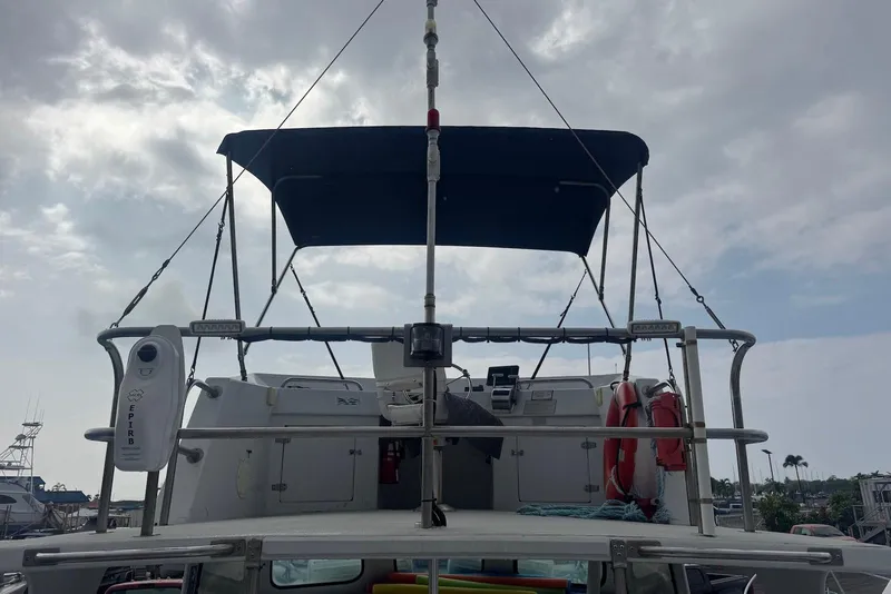 Slide: The Image of 1988 Custom 36 Hawaiian Lightning Radon boat with canopy and safety equipment. - 16