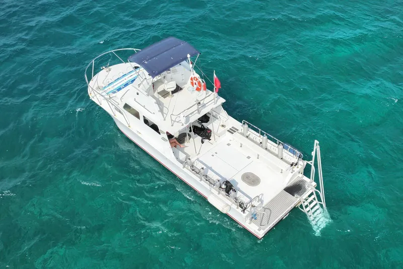 Slide: The Image of Aerial view of 1988 Custom 36 Hawaiian Lightning Radon boat on turquoise water. - 4