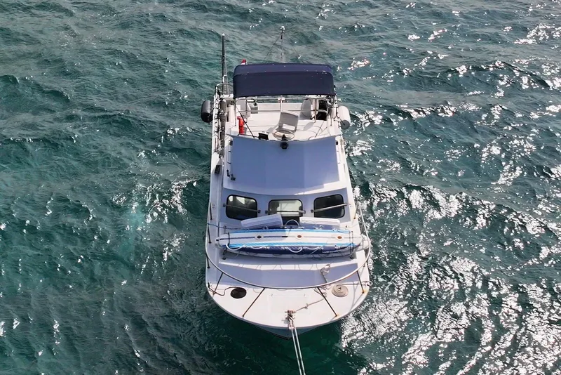 Slide: The Image of Aerial view of 1988 Custom 36 Hawaiian Lightning Radon boat on sparkling ocean water. - 6