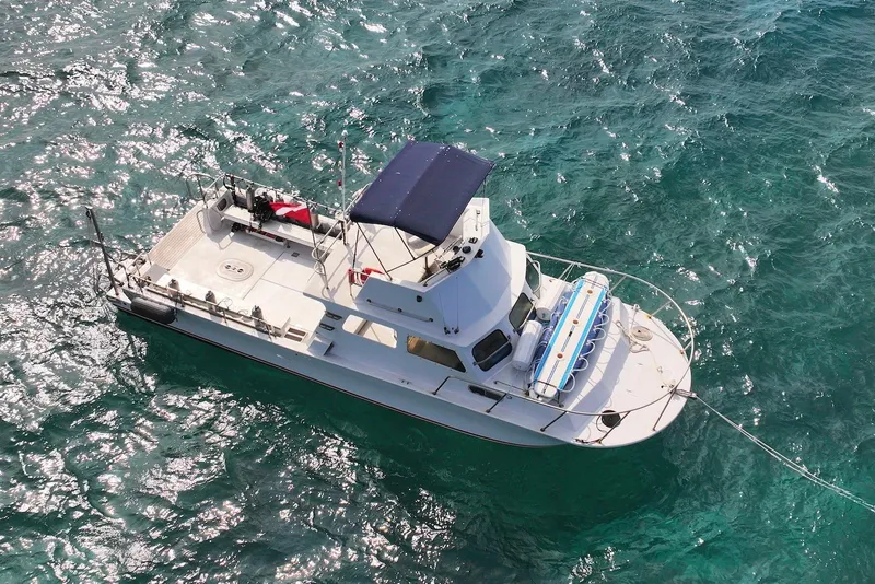 Slide: The Image of Aerial view of 1988 Custom 36 Hawaiian Lightning Radon boat on clear ocean water. - 7