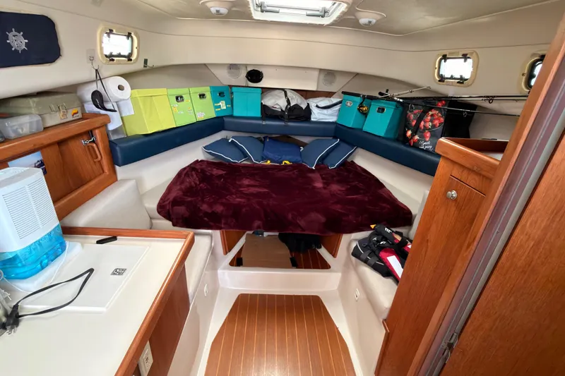 Slide: The Image of 1999 Mainship Pilot 30 helm with steering wheel, gauges, and navigation controls. - 8