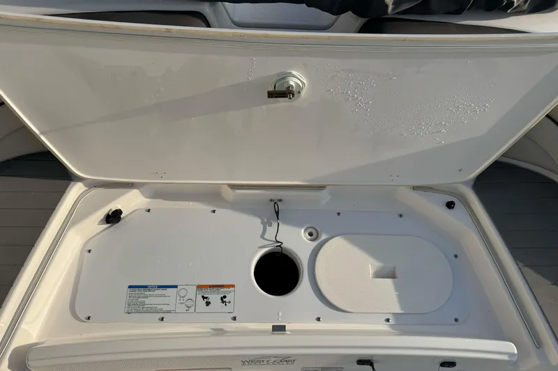 Slide: The Image of Open storage compartment of 2022 Yamaha Boats SX190, showing interior details. - 10