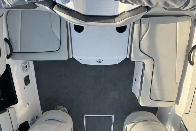Slide: The Image of 2022 Yamaha Boats SX190 interior with gray seating and carpeted floor. - 11