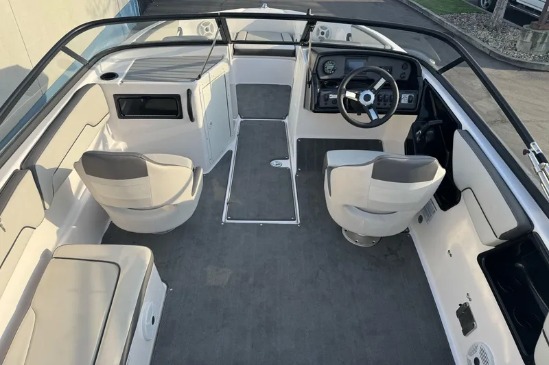 Slide: The Image of 2022 Yamaha Boats SX190 interior with dual seats, steering wheel, and spacious layout. - 12