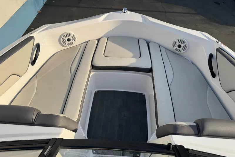 Slide: The Image of 2022 Yamaha Boats SX190 interior with cushioned seating and speakers. - 13