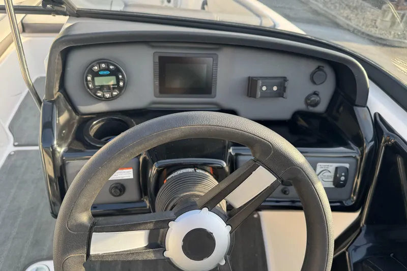 Slide: The Image of 2022 Yamaha Boats SX190 dashboard with steering wheel and control panel. - 15
