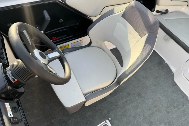 Slide: The Image of 2022 Yamaha Boats SX190 interior with steering wheel and captain's seat. - 18