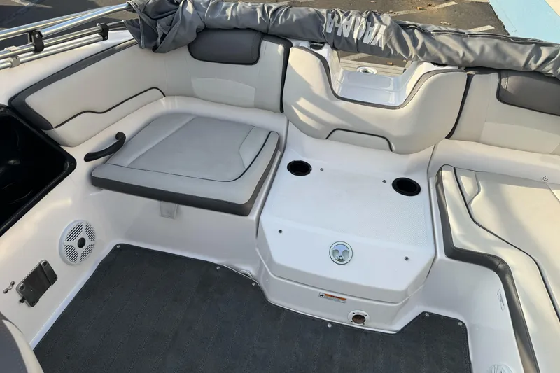 Slide: The Image of 2022 Yamaha Boats SX190 interior with cushioned seating and cup holders. - 19