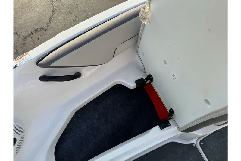 Slide: The Image of 2022 Yamaha Boats SX190 storage compartment with open lid, showcasing interior space. - 25