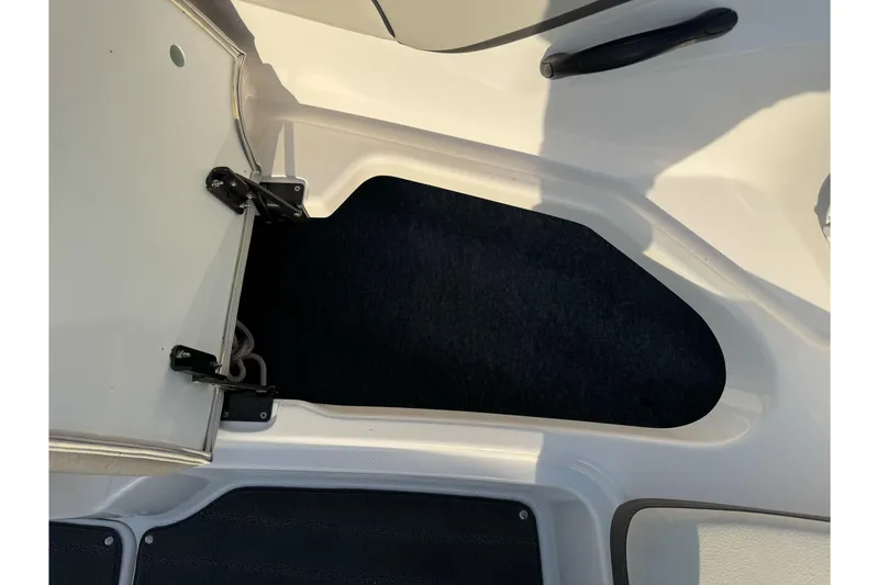 Slide: The Image of Open storage compartment on a 2022 Yamaha Boats SX190. - 27