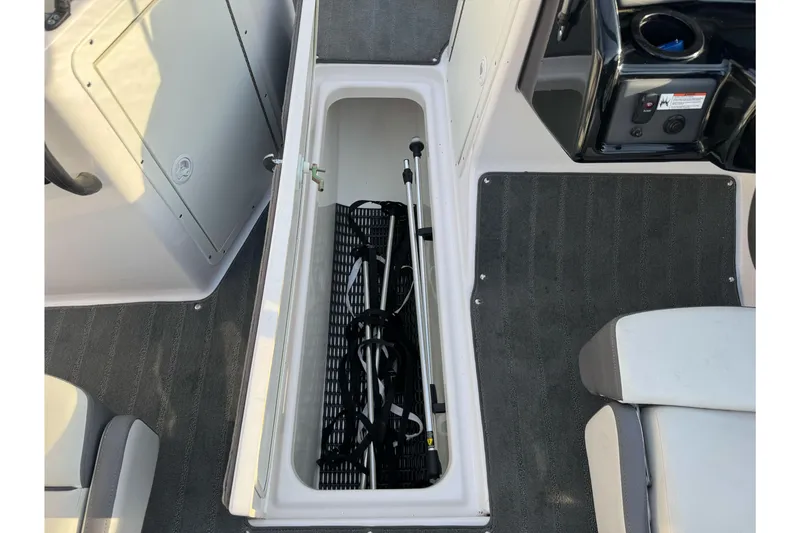 Slide: The Image of 2022 Yamaha Boats SX190 interior storage compartment with equipment. - 28