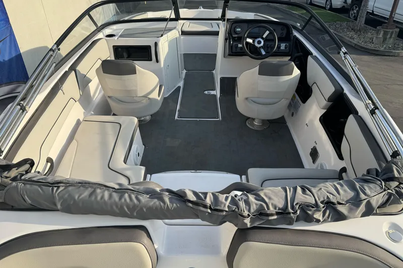 Slide: The Image of 2022 Yamaha Boats SX190 interior with seating and steering console, showcasing modern design. - 9